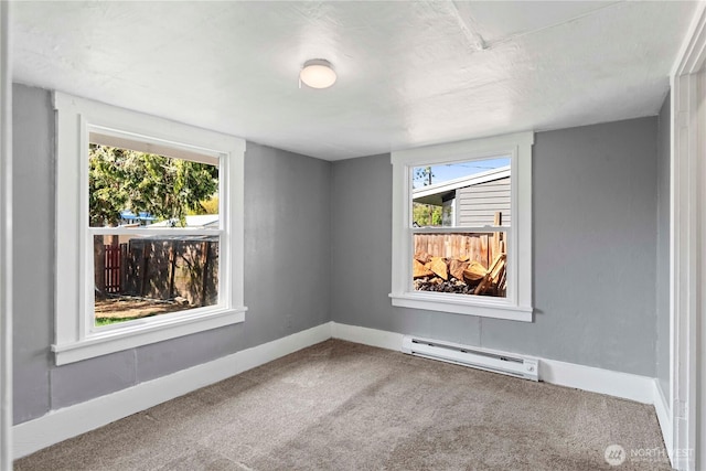 314 E Okanogan Ave, Chelan, WA 98816 - unfurnished room with baseboard heating, carpet flooring, plenty of natural light, and baseboards