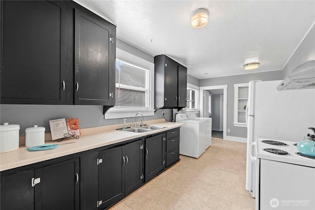 314 E Okanogan Ave, Chelan, WA 98816 - kitchen featuring a sink, washer / dryer, dark cabinetry, and light countertops