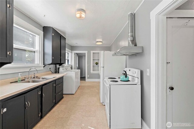 314 E Okanogan Ave, Chelan, WA 98816 - kitchen with white range with electric stovetop, washer / dryer, a sink, dark cabinets, and light countertops