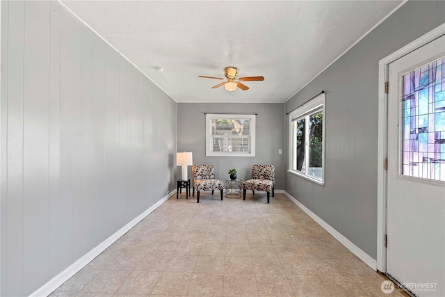 314 E Okanogan Ave, Chelan, WA 98816 - sitting room featuring healthy amount of natural light, a ceiling fan, baseboards, and ornamental molding