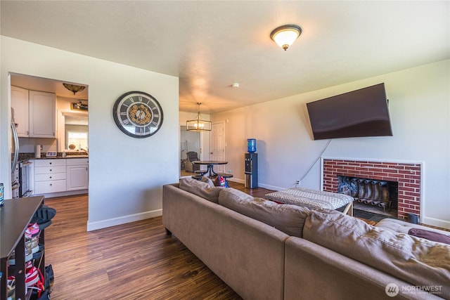 8803 Terrace Rd SW, Tacoma, WA 98498 - living room featuring dark wood-type flooring, baseboards, and a brick fireplace