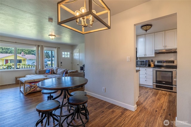 8803 Terrace Rd SW, Tacoma, WA 98498 - dining space featuring dark wood-style flooring, baseboards, and a chandelier