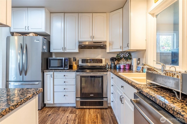 8803 Terrace Rd SW, Tacoma, WA 98498 - kitchen featuring appliances with stainless steel finishes, under cabinet range hood, wood finished floors, and white cabinetry