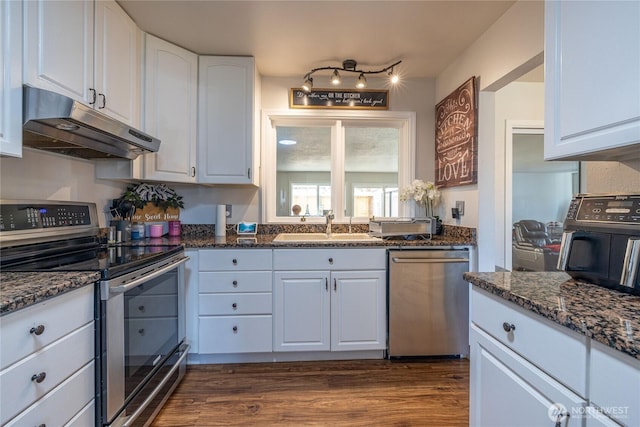 8803 Terrace Rd SW, Tacoma, WA 98498 - kitchen with stainless steel appliances, under cabinet range hood, a sink, white cabinets, and dark wood-style flooring