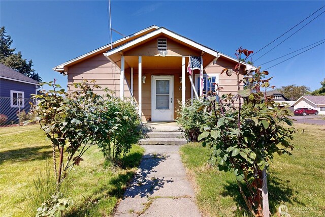 bungalow-style house featuring a front yard