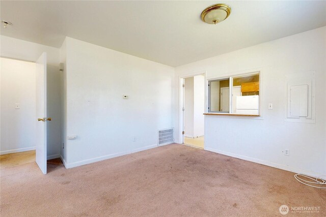 carpeted spare room with baseboards