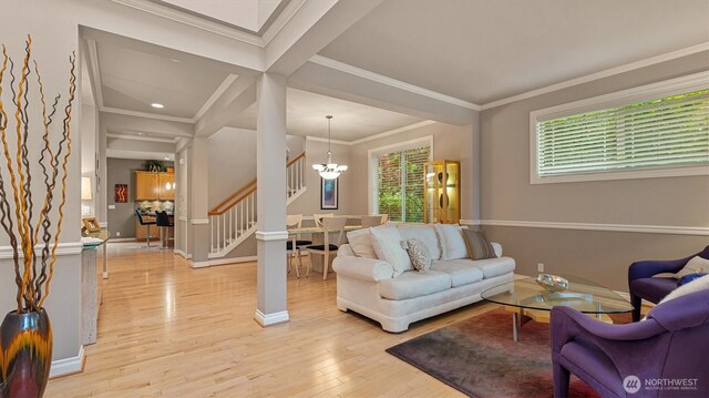 25413 NE 3rd Pl, Sammamish, WA 98074 - living room featuring a chandelier, stairs, light wood-style floors, baseboards, and crown molding