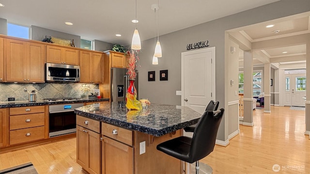 25413 NE 3rd Pl, Sammamish, WA 98074 - kitchen with stainless steel appliances, light wood-style flooring, decorative backsplash, a kitchen bar, and a center island