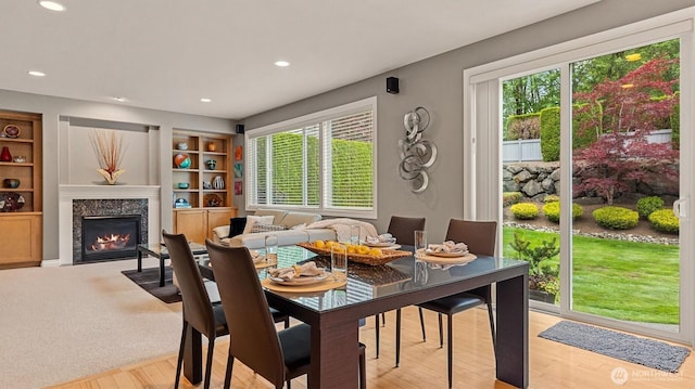 25413 NE 3rd Pl, Sammamish, WA 98074 - dining room featuring plenty of natural light, recessed lighting, a high end fireplace, built in shelves, and light wood-type flooring