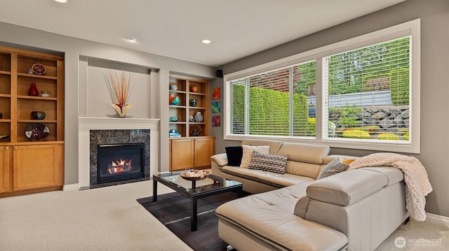 25413 NE 3rd Pl, Sammamish, WA 98074 - carpeted living area with a premium fireplace, built in shelves, baseboards, and recessed lighting
