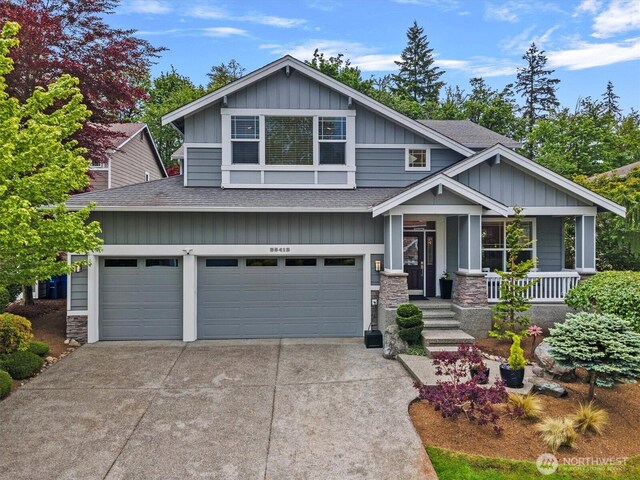 25413 NE 3rd Pl, Sammamish, WA 98074 - craftsman house with a shingled roof, board and batten siding, a porch, and driveway
