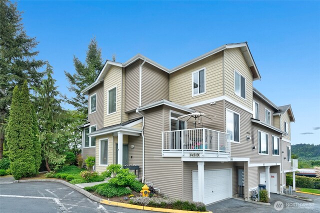 14519 1st Ln NE Unit 104, Duvall, WA 98019 - view of front facade with a balcony, a garage, and driveway