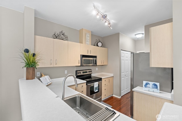 14519 1st Ln NE Unit 104, Duvall, WA 98019 - kitchen featuring stainless steel appliances, light brown cabinets, dark wood finished floors, light countertops, and a sink