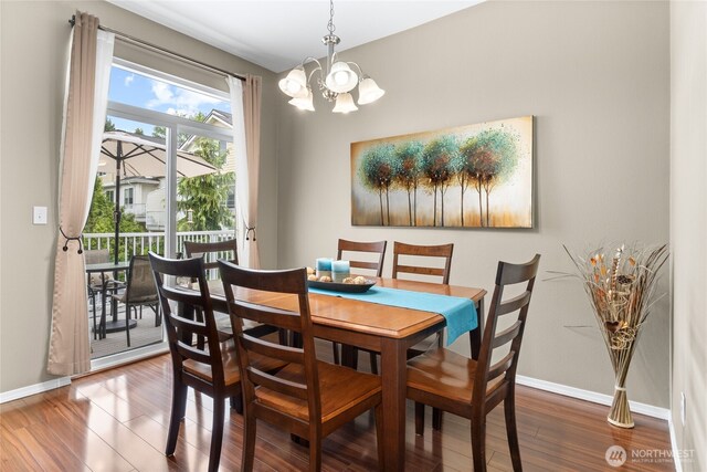 14519 1st Ln NE Unit 104, Duvall, WA 98019 - dining space with a chandelier, wood finished floors, and baseboards