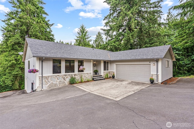 1027 Fishpond Rd, Kelso, WA 98626 - ranch-style house featuring driveway, stone siding, and roof with shingles