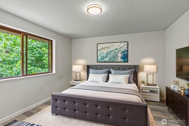 1027 Fishpond Rd, Kelso, WA 98626 - bedroom with a textured ceiling, wood finished floors, and baseboards