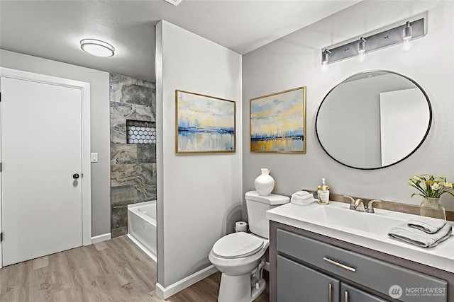 1027 Fishpond Rd, Kelso, WA 98626 - bathroom with vanity, wood finished floors, toilet, bathing tub / shower combination, and baseboards