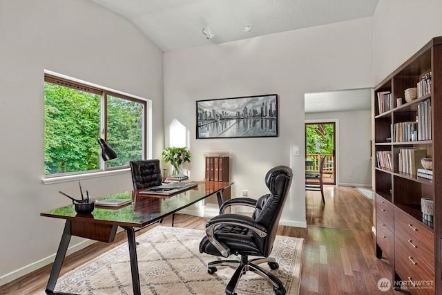 1027 Fishpond Rd, Kelso, WA 98626 - office space with vaulted ceiling, dark wood finished floors, and baseboards