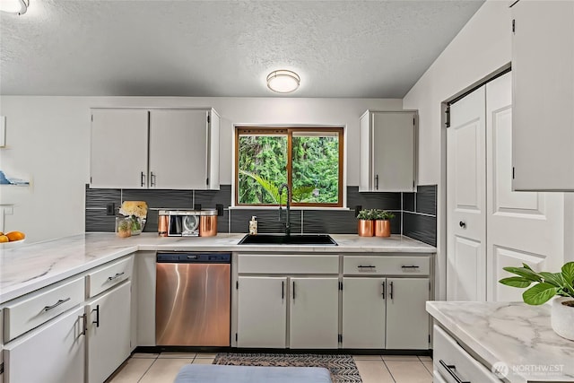 1027 Fishpond Rd, Kelso, WA 98626 - kitchen featuring dishwasher, a sink, light tile patterned floors, a textured ceiling, and backsplash