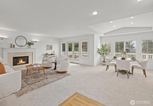living area featuring recessed lighting, carpet flooring, baseboards, and a premium fireplace