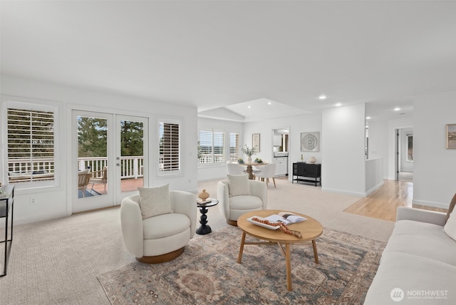 living area with recessed lighting, baseboards, light colored carpet, and french doors