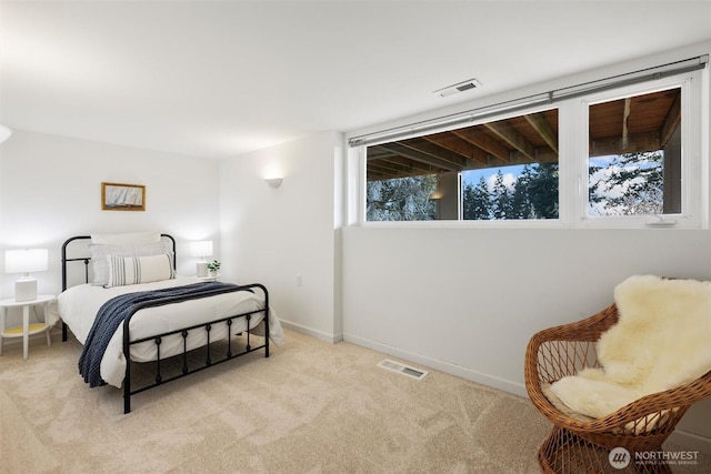 bedroom with baseboards, visible vents, and carpet