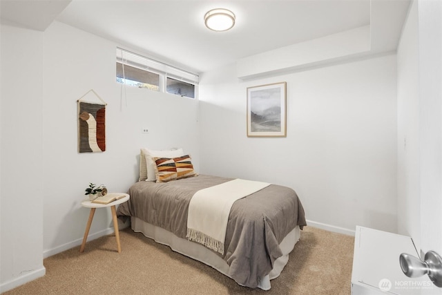 bedroom featuring baseboards and light carpet