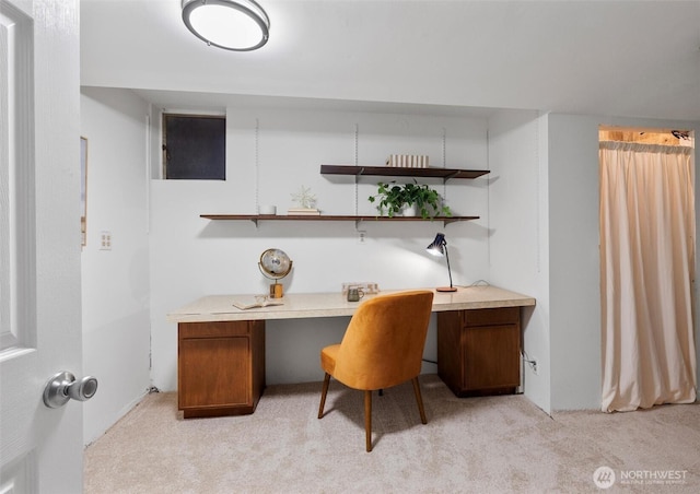 home office featuring light carpet and built in study area