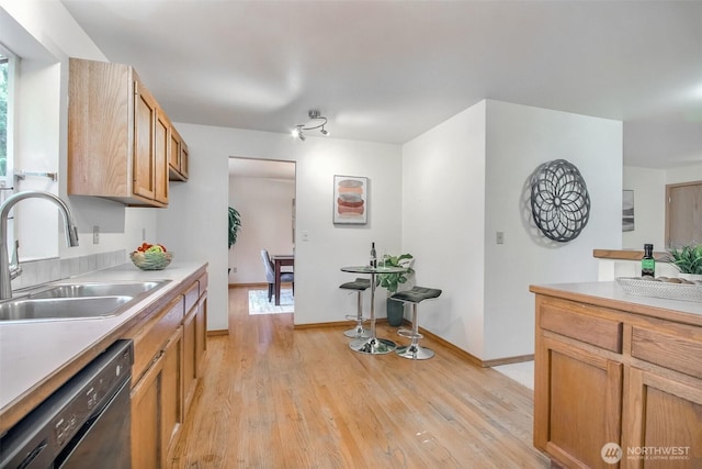 1742 N 122nd St, Seattle, WA 98133 - kitchen featuring a sink, black dishwasher, light wood-style floors, and light countertops