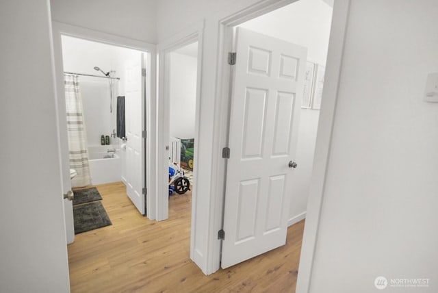 corridor with light wood-type flooring