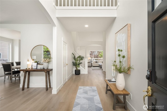 24858 NE 1st Pl, Sammamish, WA 98074 - foyer featuring arched walkways, light wood-style flooring, a towering ceiling, baseboards, and recessed lighting