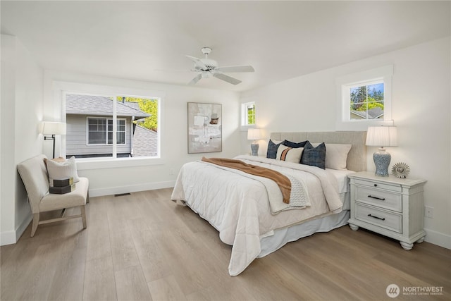 24858 NE 1st Pl, Sammamish, WA 98074 - bedroom with multiple windows, wood finished floors, and baseboards
