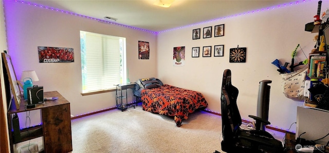 bedroom with carpet floors, baseboards, and visible vents