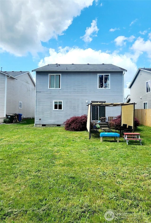back of house with a yard and fence
