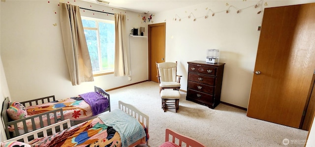 bedroom featuring baseboards and carpet