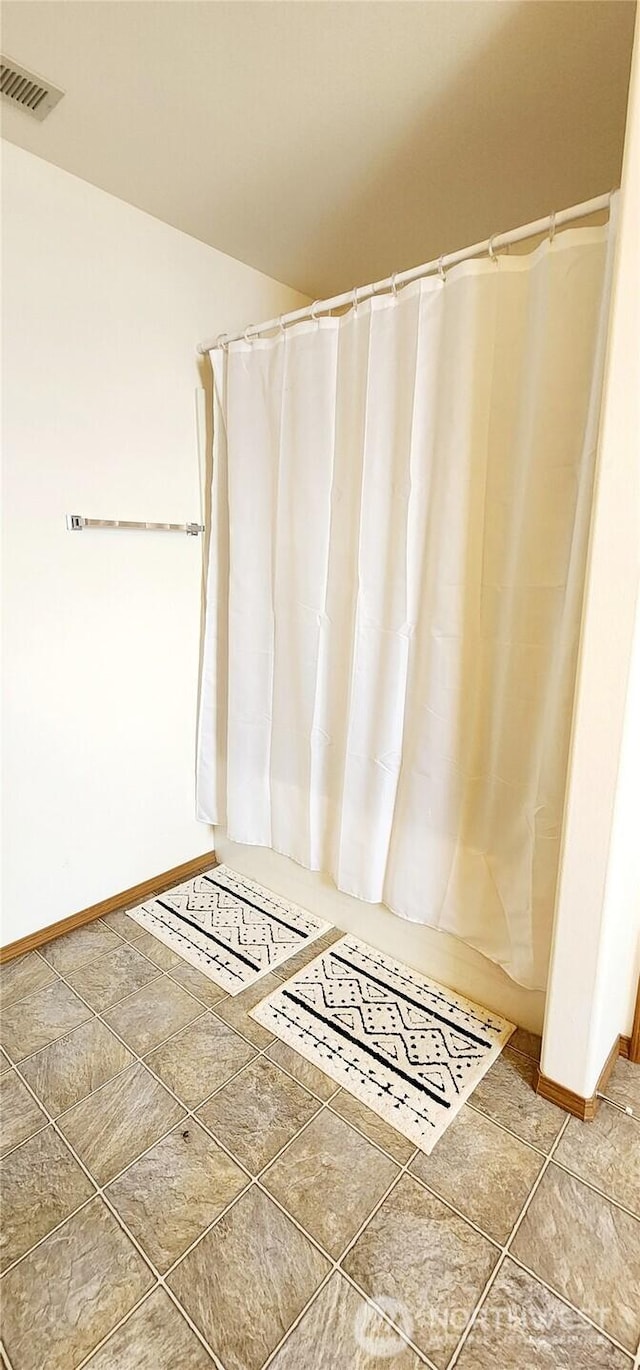bathroom featuring baseboards and visible vents