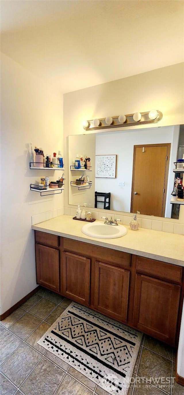 bathroom with vanity and baseboards
