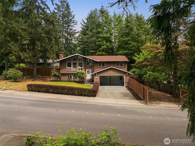 3131 110th St SE, Everett, WA 98208 - bi-level home featuring fence, driveway, a garage, and a chimney