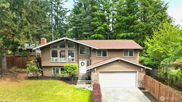 3131 110th St SE, Everett, WA 98208 - split foyer home with a chimney, gravel driveway, stone siding, and a garage