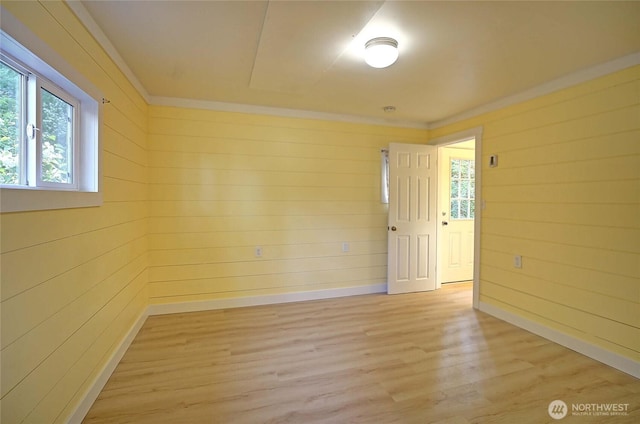 566 Sundin Dr, Camano Island, WA 98282 - unfurnished room with light wood finished floors, wooden walls, crown molding, and baseboards