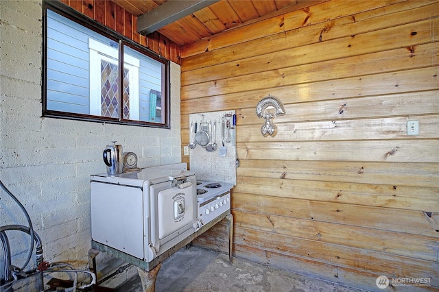interior space with wood ceiling, wood walls, concrete flooring, and vanity