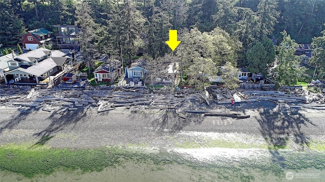 bird's eye view with a wooded view