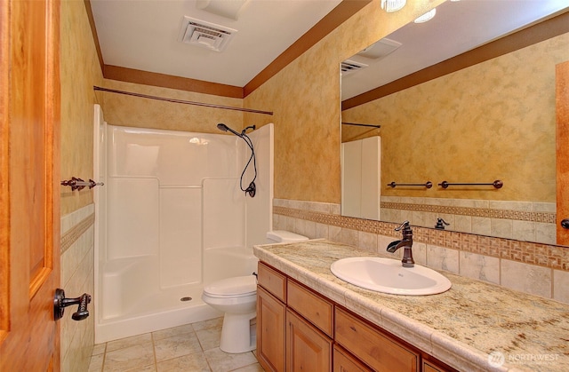 bathroom with toilet, a shower, vanity, visible vents, and tile patterned flooring