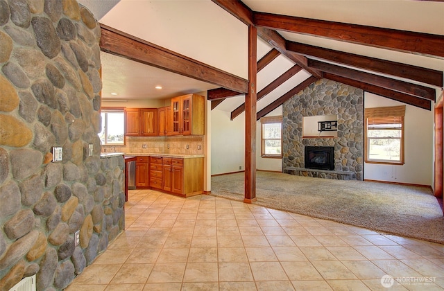 unfurnished living room featuring recessed lighting, lofted ceiling with beams, light tile patterned flooring, light carpet, and a fireplace