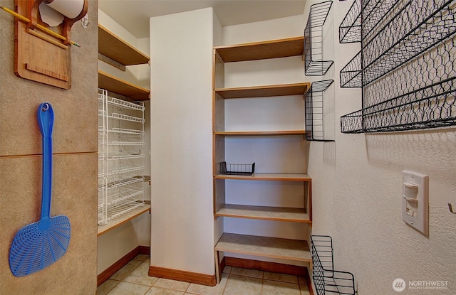 walk in closet with tile patterned flooring