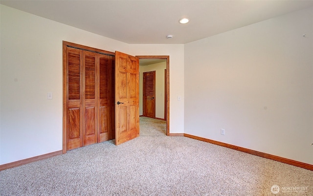 unfurnished bedroom featuring baseboards, a closet, recessed lighting, and light colored carpet