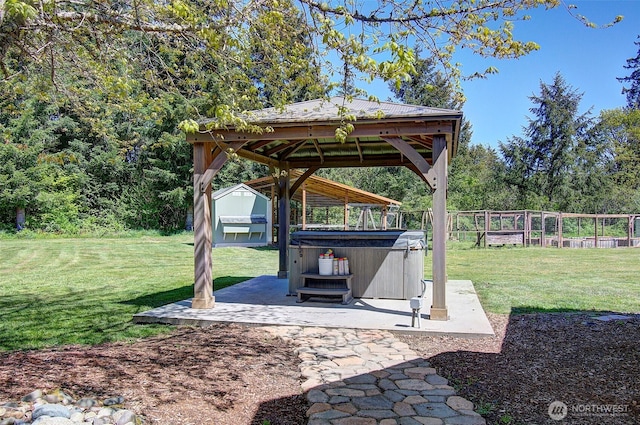 view of yard with a hot tub, a gazebo, fence, and a patio area