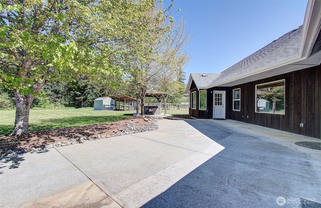 view of patio / terrace featuring an outdoor structure and a shed