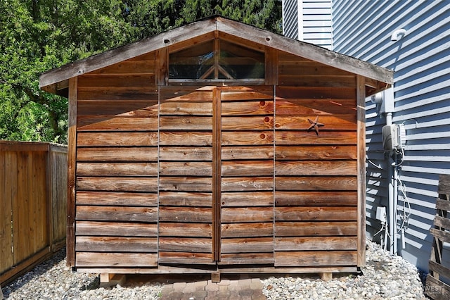 view of shed with fence