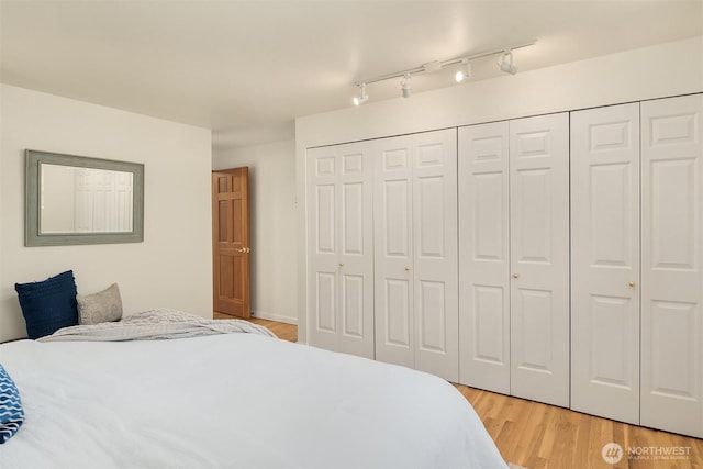 12802 NE 26th Pl, Bellevue, WA 98005 - bedroom with light wood-style flooring, a closet, and track lighting